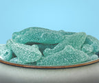 Blue shark shaped candy in a white stone bowl sugar free