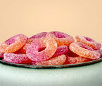 Gummy candy rings on a plate with a beige background sugar free