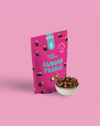 Pink package of Sweet Switch Almond Pearls with a bowl of almonds on a pink background sugar free