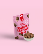 Pink package of Sweet Switch Belgian Truffles with a bowl of truffles on a pink background sugar free