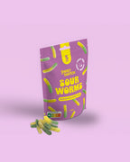 Purple package of Sweet Switch Sour Worms on a pink background sugar free