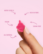 Pink unicorn candy held between fingers with health benefits text on a pink background sugar free