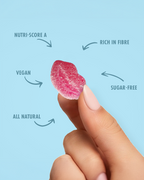 Pink lip shaped gummy candy held between fingers with health benefits text on a light blue background sugar free