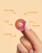 Hand holding a gummy candy with nutritional information text on a beige background sugar free