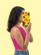 Woman holding a chocolate bar with a yellow background sugar free