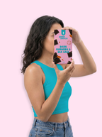 Woman holding a snack package in front of her face against a pink background sugar free